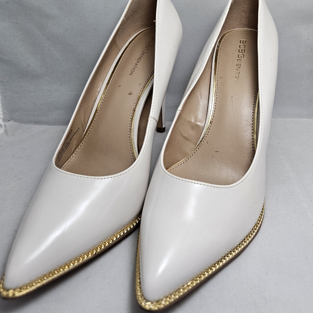 BCBGeneration Women's White Pumps with Gold Trim